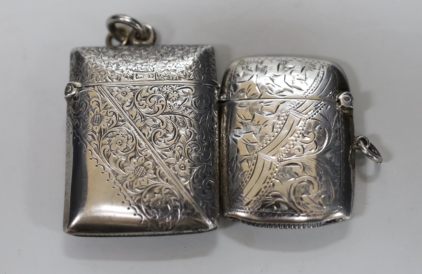 Two 20th century silver sugar casters, tallest 16.4cm and two early 20th century silver vesta cases.